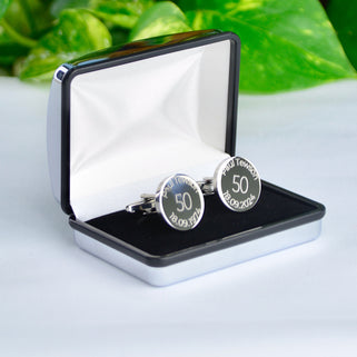 Milestone 50th birthday cufflinks with personalised name and date engraved around the top and bottom, shown in silver chrome rectangle cufflinks box.