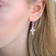 Sterling silver drop earrings with choice of charm shown on model with cross charm