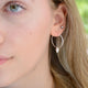 Sterling Silver Hoop Earrings with charm of your choice showing a hoop with acorn close up on model