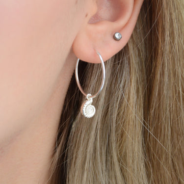 Sterling Silver Hoop Earrings with charm of your choice showing a hoop with ammonite close up on model