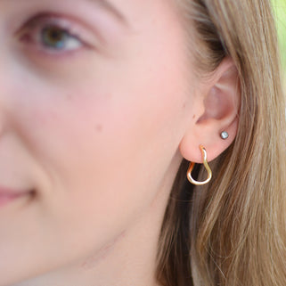 Gold Organic Twist Hoop Earrings shown close up on model