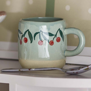 Baby Blue stoneware mug with hand painted red and green cherries around the top. 