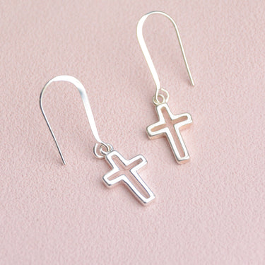 Sterling silver drop earrings with choice of charm shown close up with cross charm