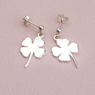 Sterling Silver dangle stud earring with choice of charm shown close up with clover charm