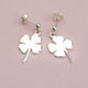 Sterling Silver dangle stud earring with choice of charm shown close up with clover charm