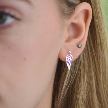 Sterling Silver dangle stud earring with choice of charm shown close up on model with angel wing charm