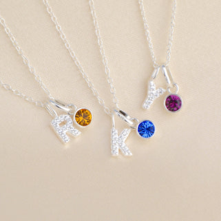 Silver Sparkle Initial and Birthstone Necklaces close up - Letter R and January/Garnet birthstone, Letter K and September/Sapphire birthstone,  Letter Y and October/Tourmaline birthstone