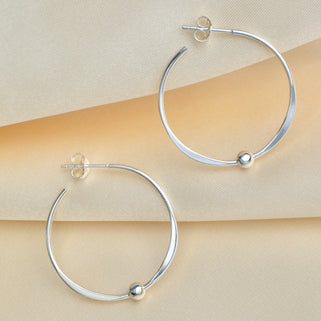 Sterling Silver large Hoop Earrings With Beads shown close up .