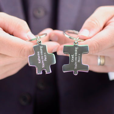 Personalised Couples Jigsaw Keyrings Set shown close up with model