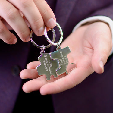 Personalised Couples Jigsaw Keyrings Set shown close up with model