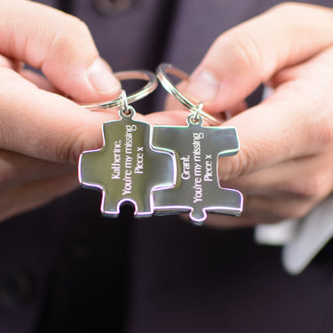 Personalised Couples Jigsaw Keyrings Set shown close up with model