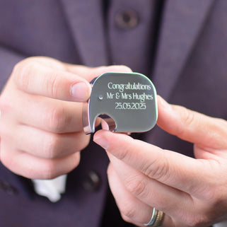 Elephant Shaped Bottle Opener with "Congratulations Mr & Mrs Hughes 25.05.2025" engraved on the front, shown close up with model