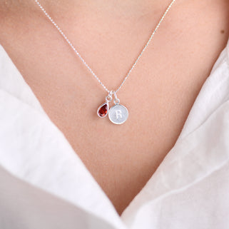 Personalised Silver Girls Initial Teardrop Birthstone Necklace shown close up on model with July Birthstone