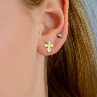 Gold plated Faceted Cross Stud Earrings shown close up on model