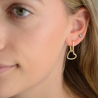 Gold Heart Shape Drop Hoop Earrings shown close up on model