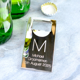 Silver Bottle Opener with personalised initial "M" engraved in the centre and "Michael Groomsman 15th August 2025" engraved below, shown in close up shot with beer bottle.