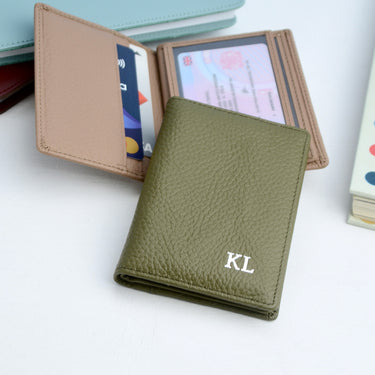 Olive monogram leather card holder with silver monogram and taupe card holder behind.