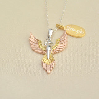 Personalised Phoenix Strength Positivity Pendant with engraved gold charm shown close up with text Strength