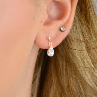 Sterling Silver Teardrop Birthstone Dangle Stud Earrings shown close up with April/Clear birthstone