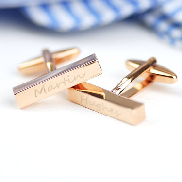 Graduation rose gold bar cufflinks with first name engraved on left cufflink and last name engraved on right cufflink shown in closeup shot.