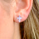 Sterling Silver Faceted Cross Stud Earrings shown close up on a model