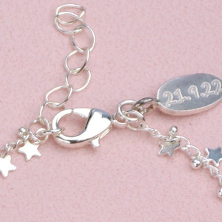 Engraved oval disc charm attached at the clasp