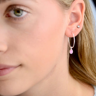 Sterling Silver Teardrop Birthstone Hoop Earrings shown close up with October birthstone