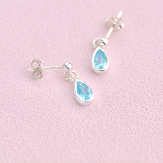 Sterling Silver Teardrop Birthstone Dangle Stud Earrings shown close up with March Birthstone