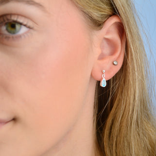 Sterling Silver Teardrop Birthstone Dangle Stud Earrings showing March birthstone closeup on model