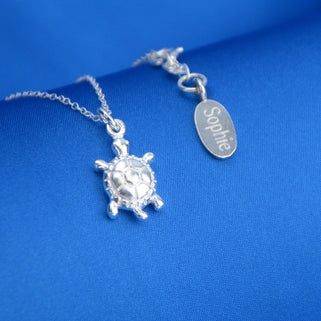 Sterling Silver Turtle Necklace with personalised "Sophie" engraved oval disc shown in close up shot