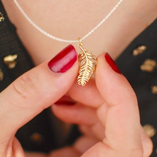 Gold store feather necklace