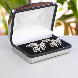 Silver racer bike cufflinks shown in silver chrome rectangle cufflinks box.