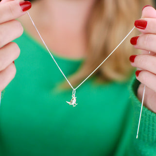 Robin Charm Necklace close up shot of model holding it