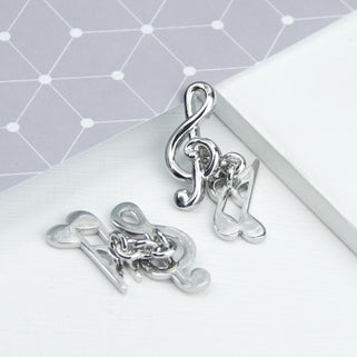 Treble clef music note cufflinks shown in close up shot