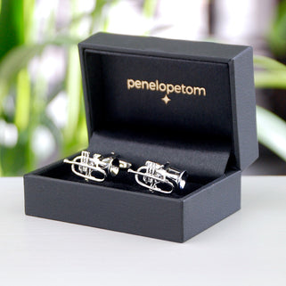 Silver trumpet cufflinks shown in black Penelopetom cufflinks box