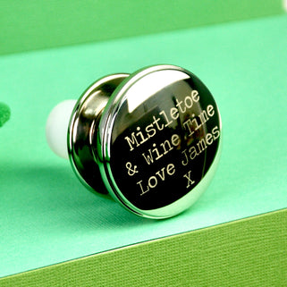 Christmas Wishes Wine Bottle Stopper with Personalised message "Mistletoe & Wine Time Love James X" engraved on top of stopper shown in close up shot